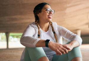 Shot of a sporty young woman taking a break while exercising outdoors